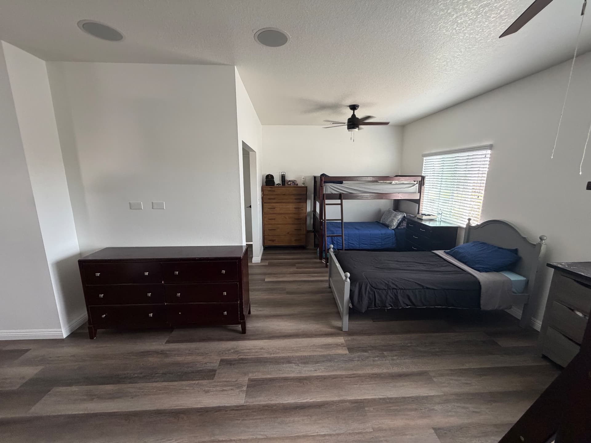 Large bedroom with bunk beds and dressers