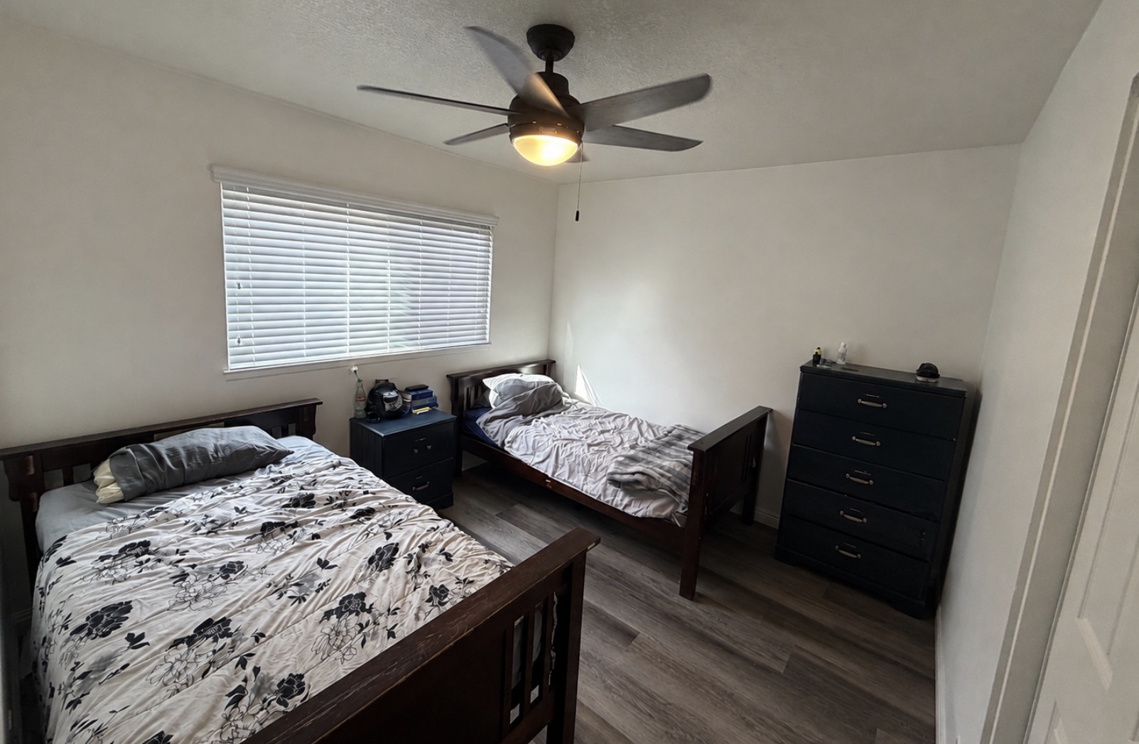 Bedroom with two beds, nightstand and dresser