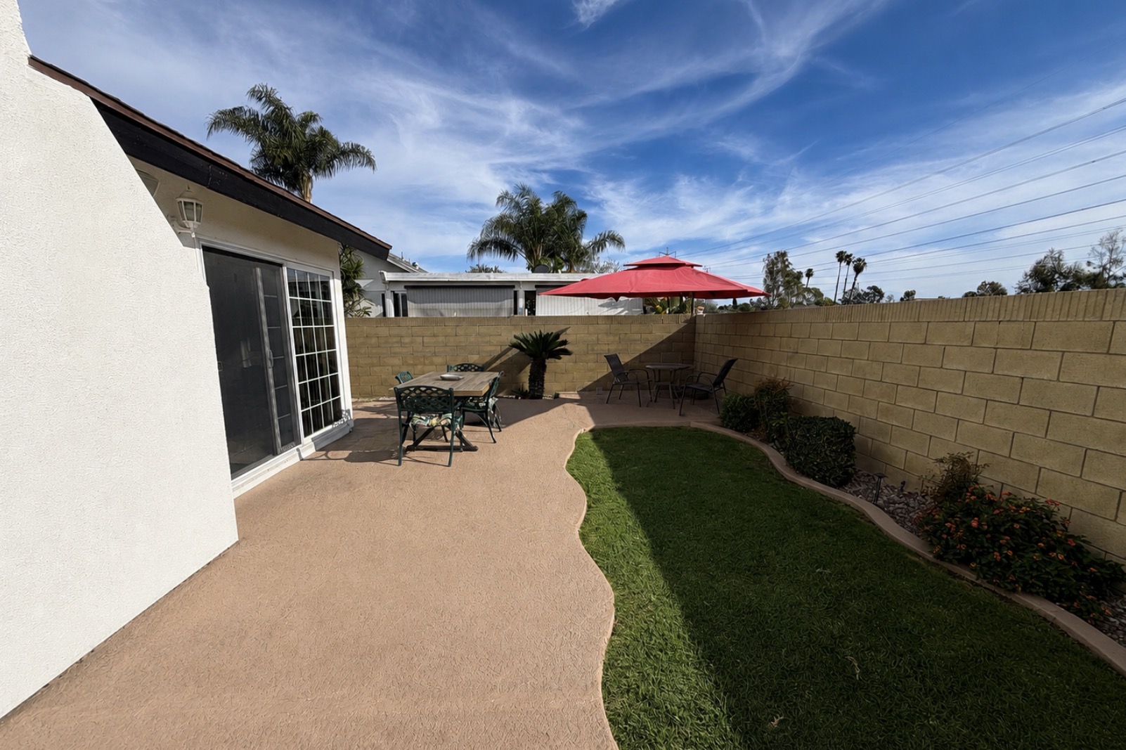 Sunlit back patio and yard at the Essence Intensive recovery home