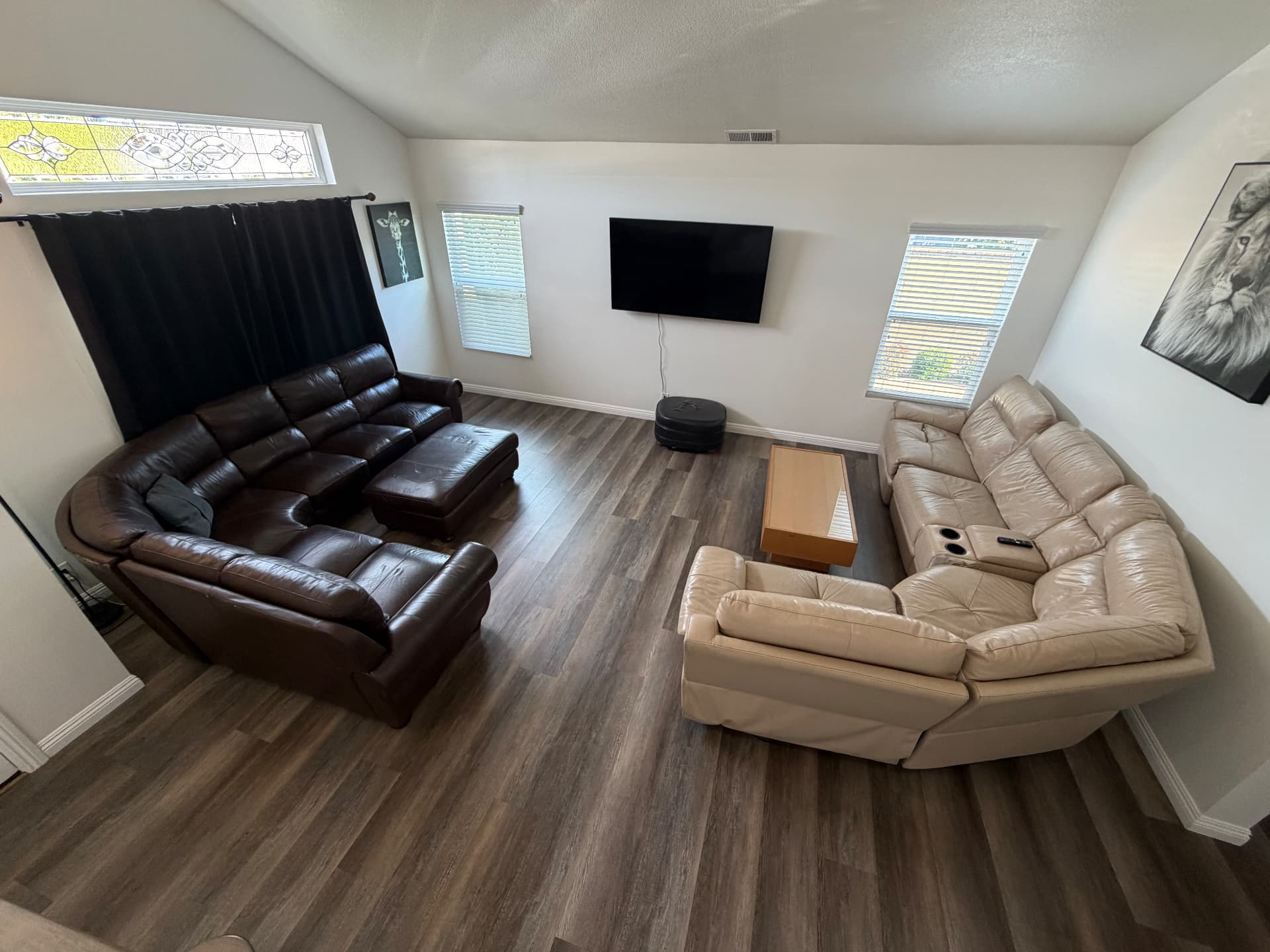 Main living room with sectional seating and mounted TV