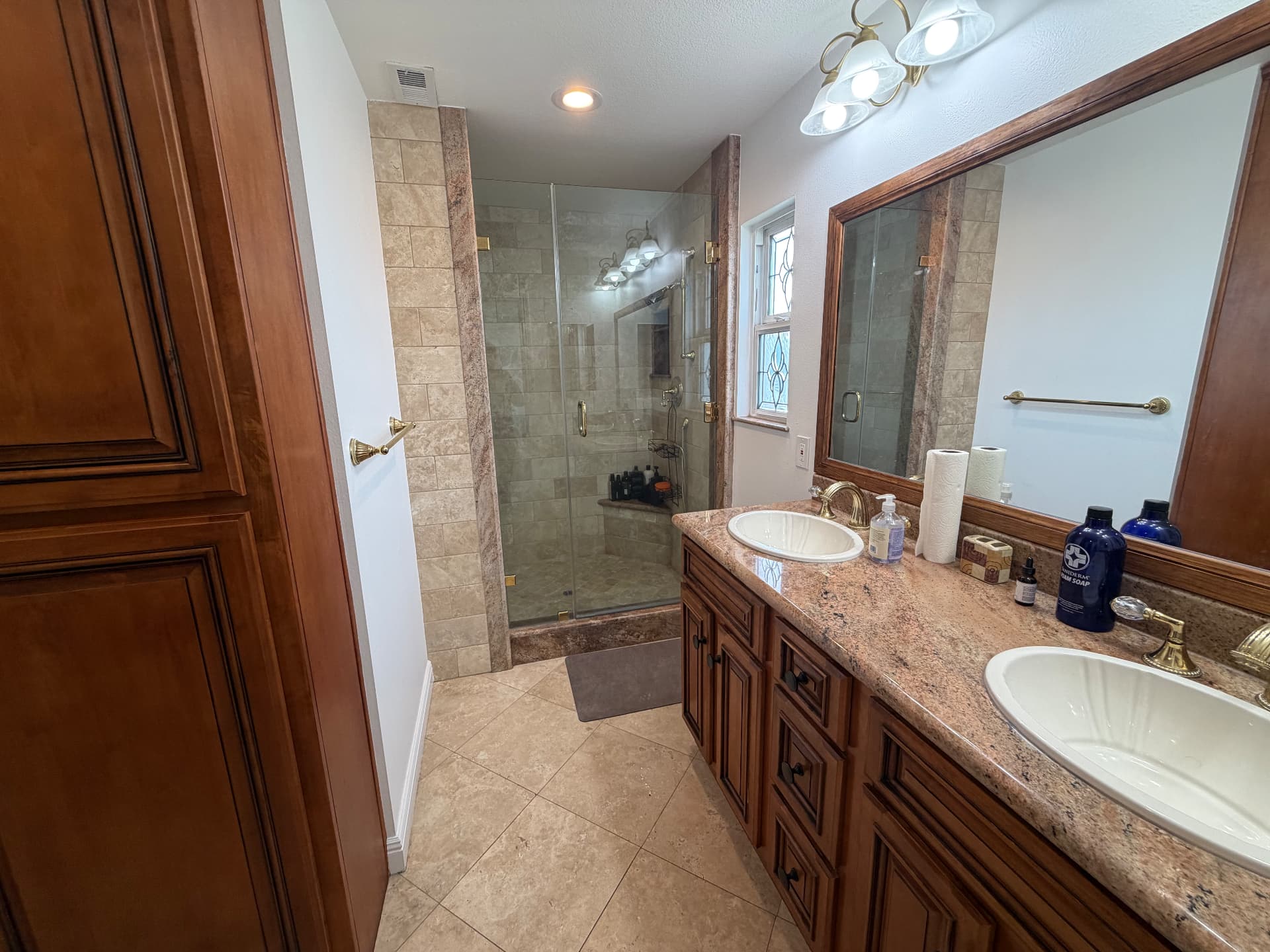 Full bathroom with double vanity and walk-in shower